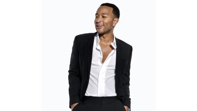 John Legend, an EGOT winner, poses while looking away from the camera.