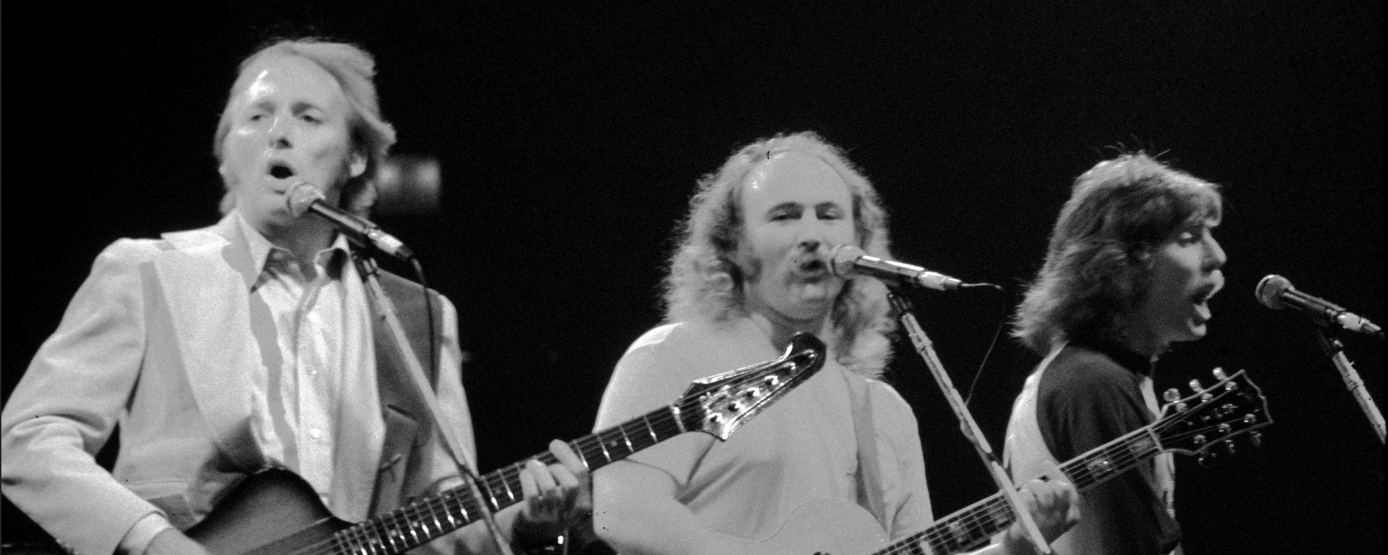 Crosby, Stills & Nash performing on stage together.