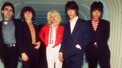 Chris Stein, Gary Valentine, Debbie Harry, Jimmy Destri and Clem Burke of Blondie posing in a neon tunnel in NYC.