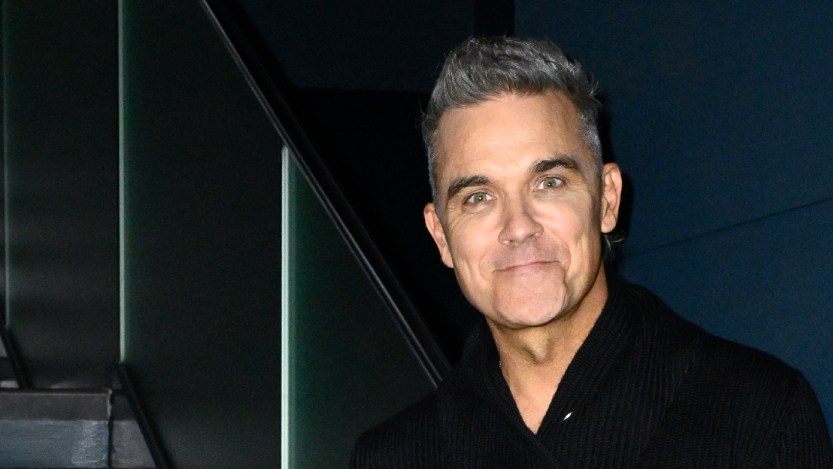 Guy Chambers Reveals How His Head Was About to "Explode" When Recording "Angels" With Robbie Williams