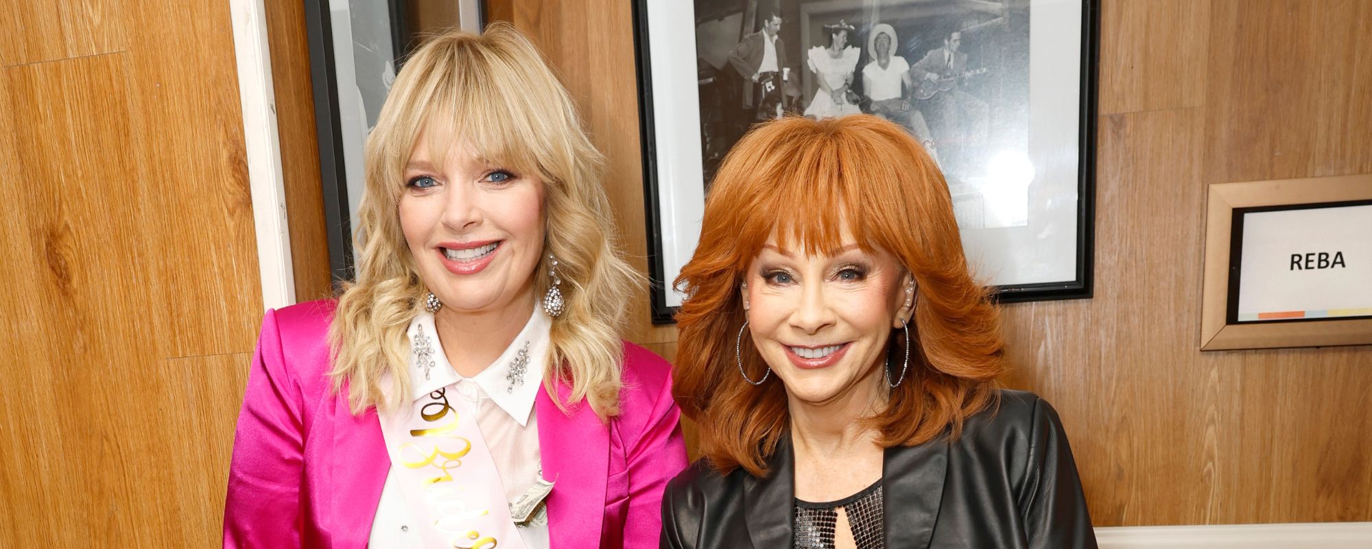 Reba McEntire in black and Melissa Peterman in pink in November 2023.