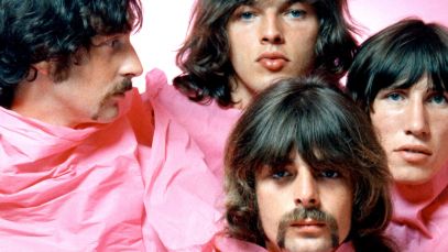 Pink Floyd poses together under pink sheet