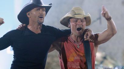 Tim McGraw and Kenny Chesney hug one another onstage