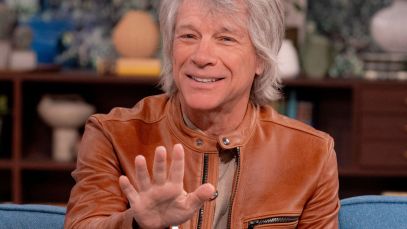 Jon Bon Jovi speaking, hand outstretched