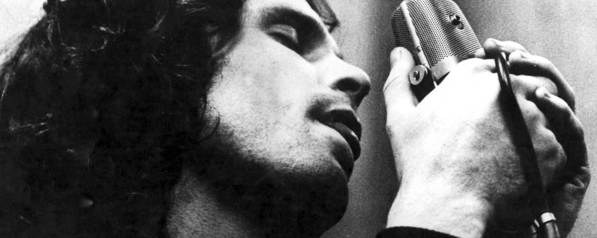 Jim Morrison singing into microphone