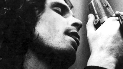 Jim Morrison singing into microphone