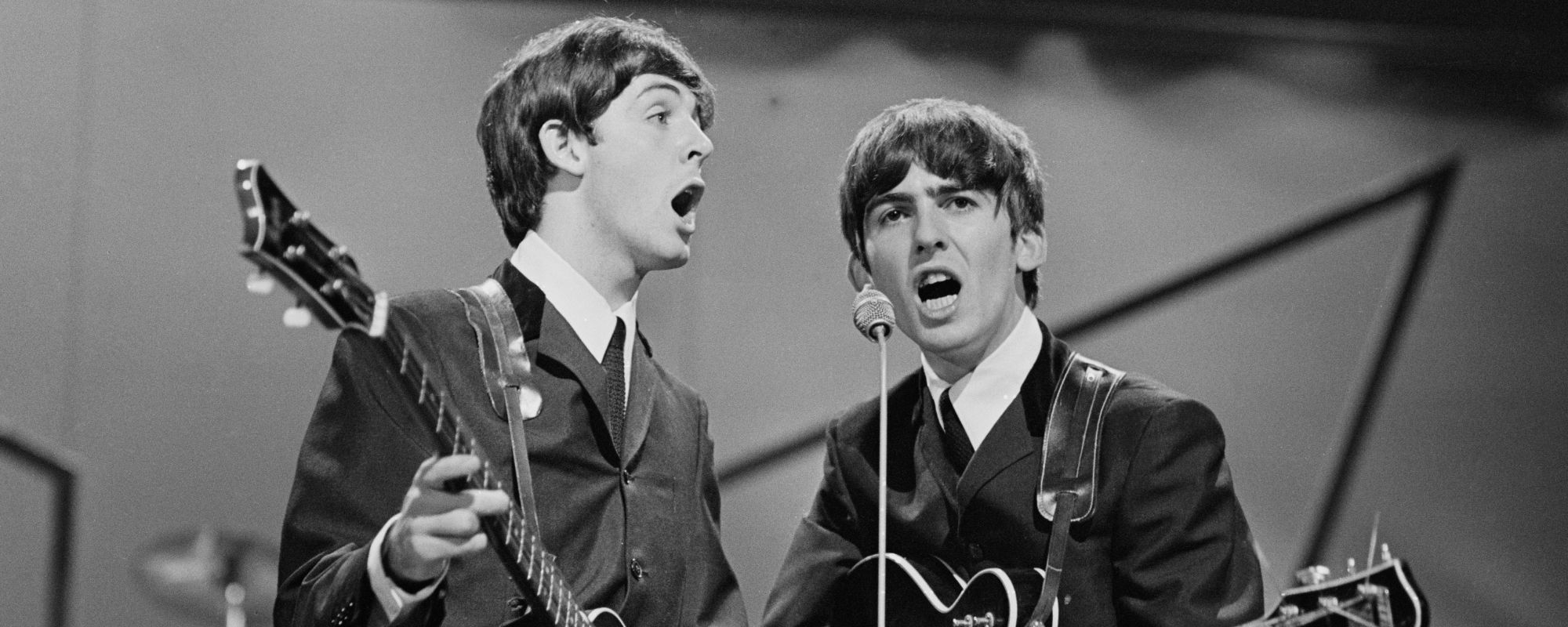 Paul McCartney and George Harrison performing