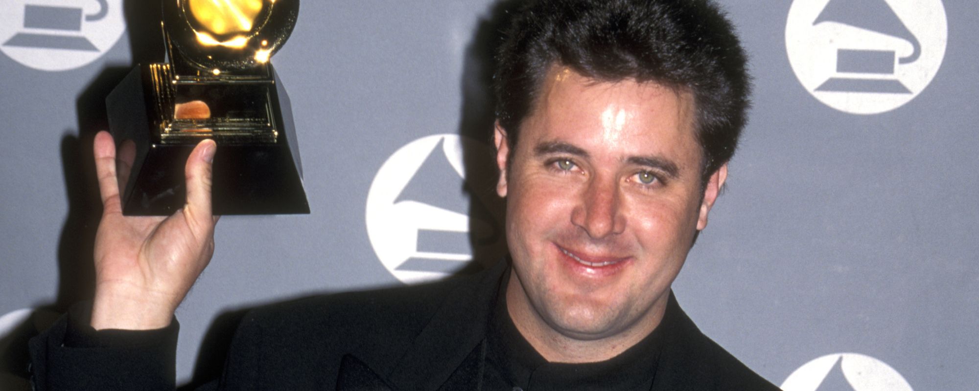 Vince Gill holding Grammy award