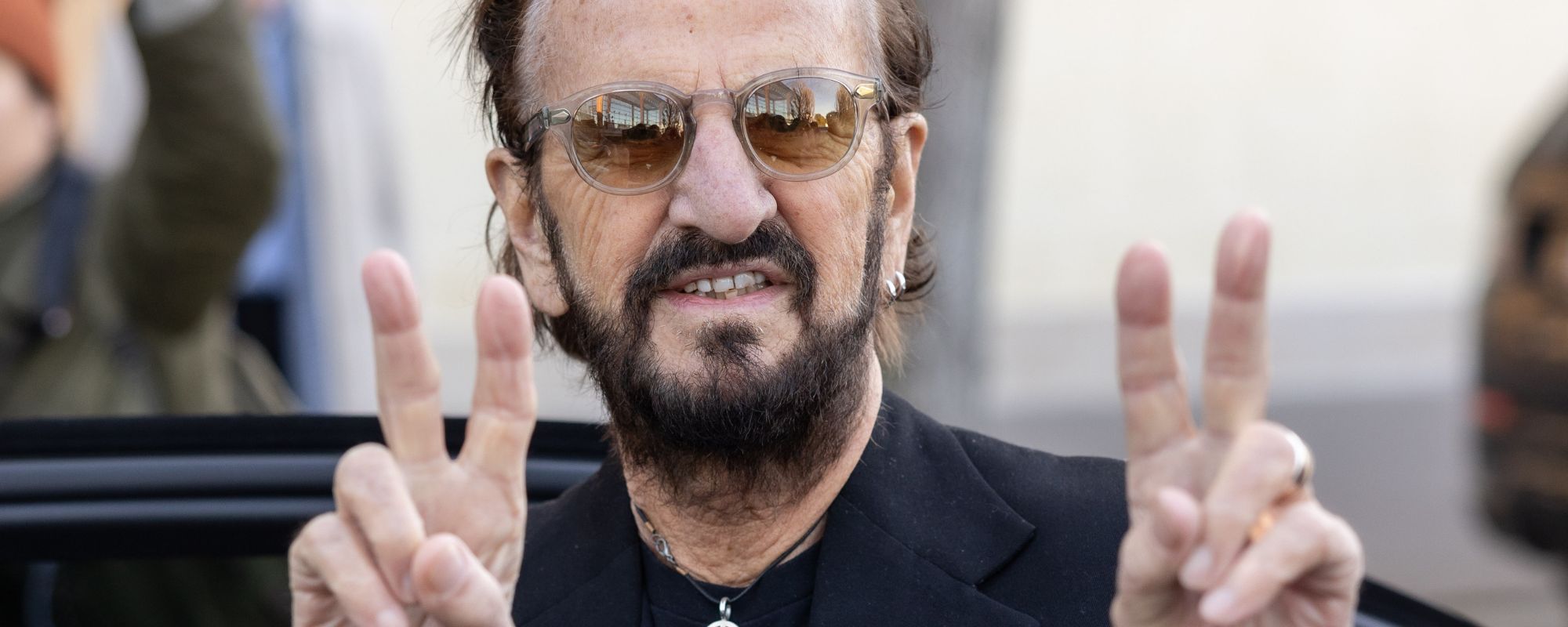 Ringo Starr making peace signs