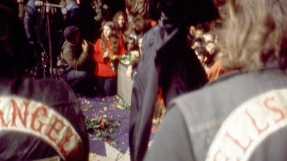Hells Angels stand on stage while Rolling Stones perform at the Altamont Speedway Free Festival