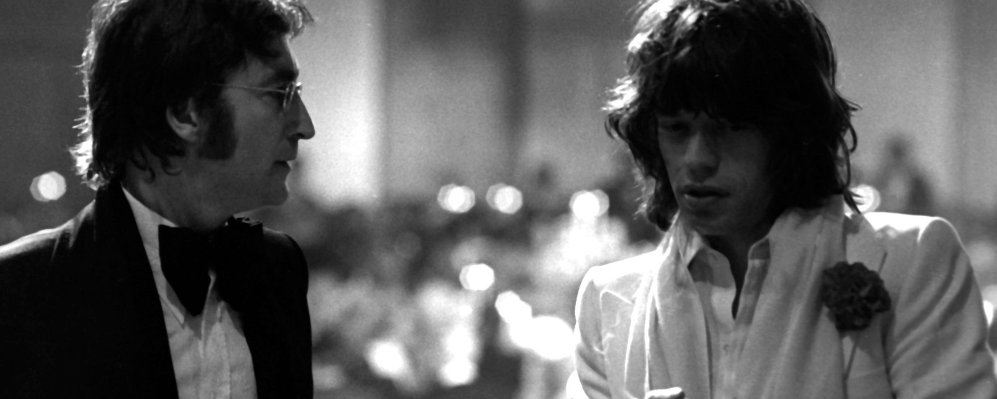 John Lennon and Mick Jagger standing together