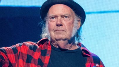 Neil Young holding microphone up