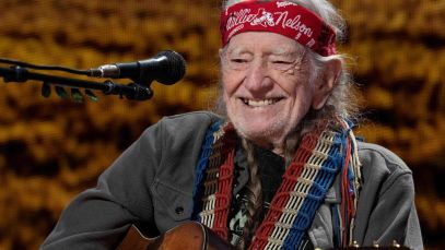 Willie Nelson smiling on stage