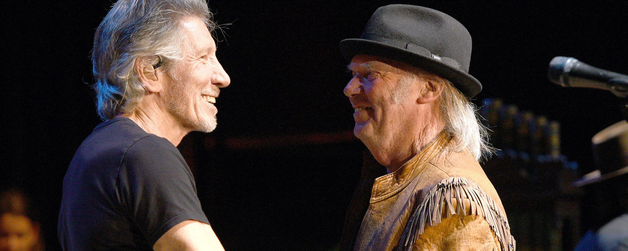 Roger Waters and Neil Young standing together