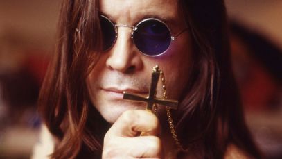 Ozzy Osbourne holding cross