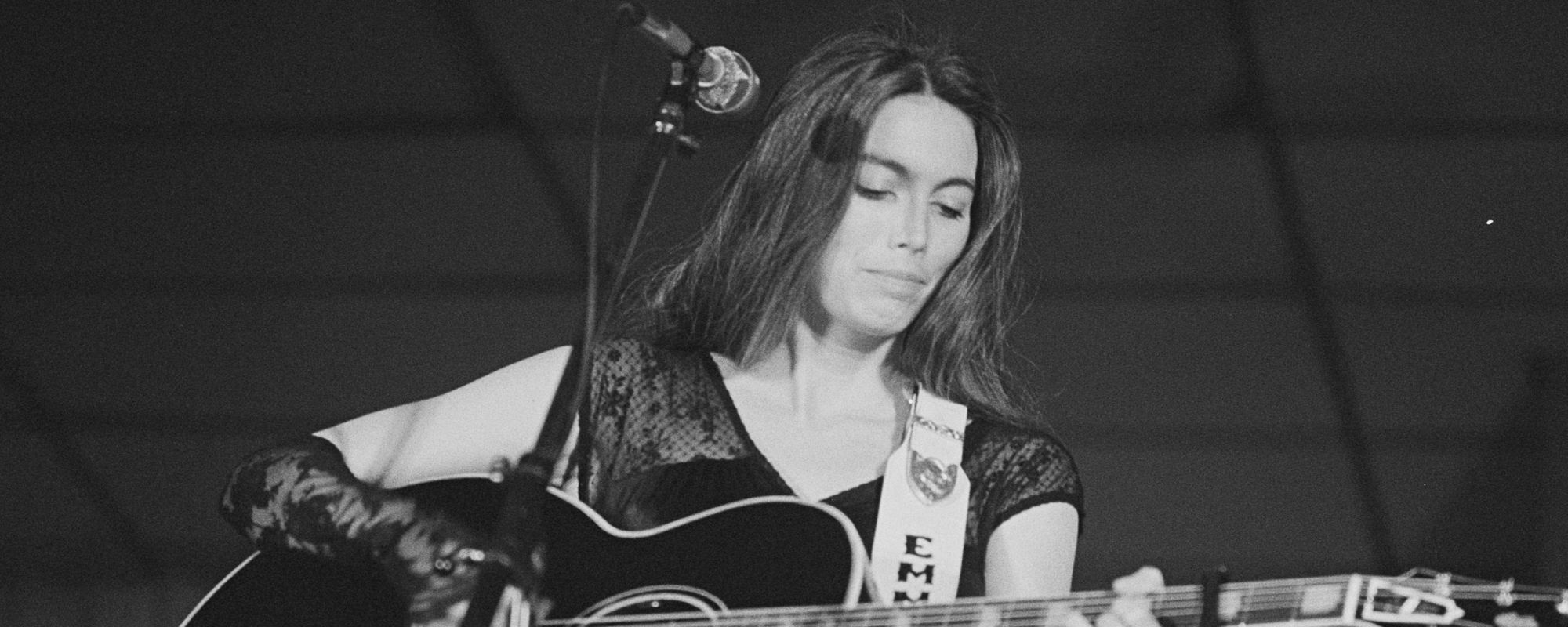 Emmylou Harris playing guitar